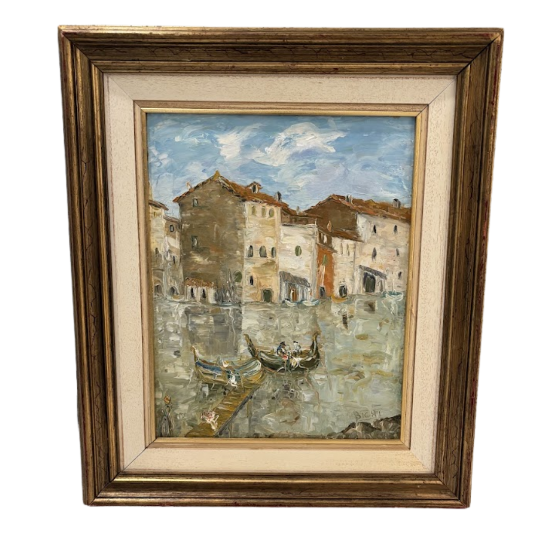 Framed painting of a canal scene with buildings and boats.
