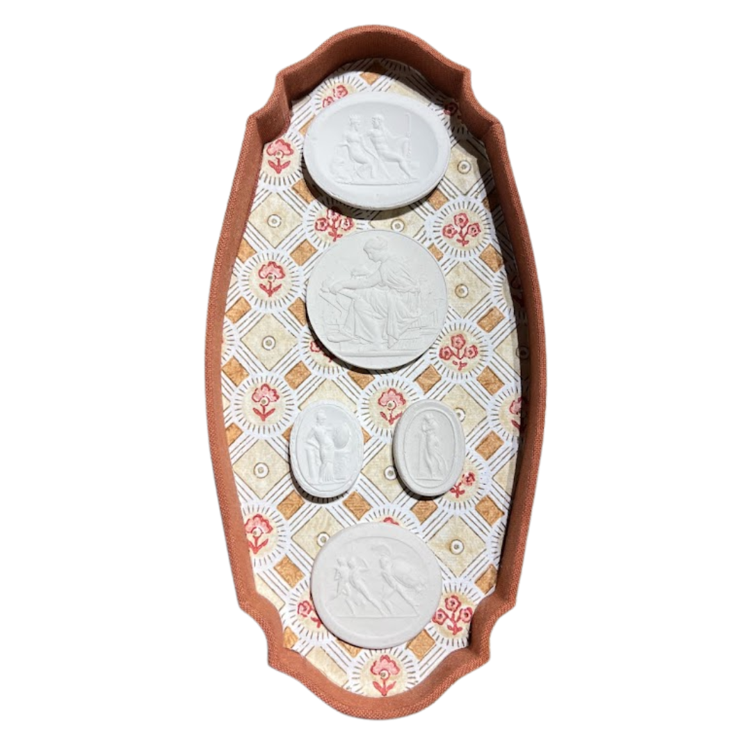 Decorative wall art with four circular white figures on a patterned background