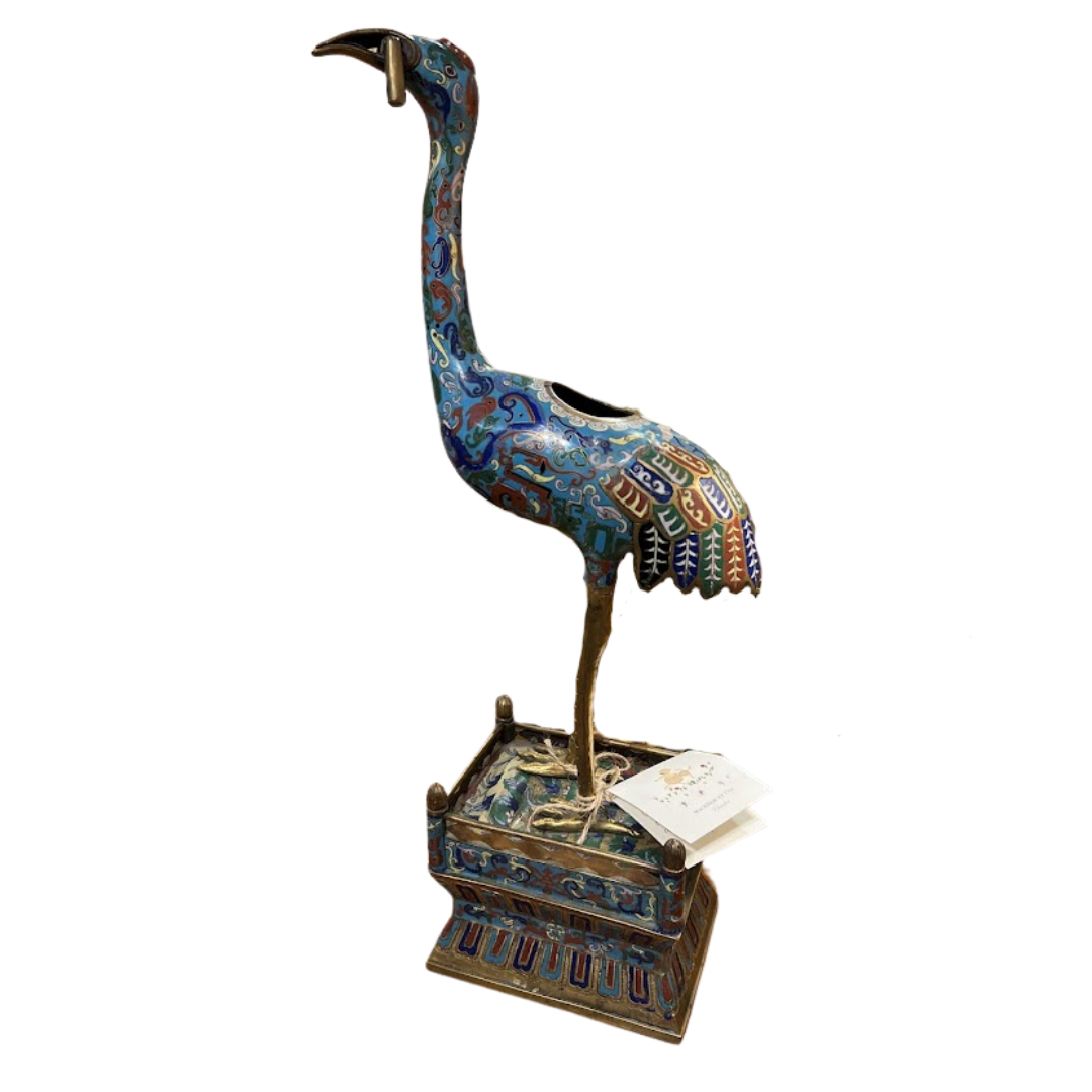 Decorative bird sculpture with intricate patterns on a white background