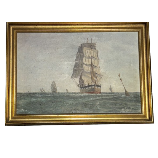 Framed painting of a ship on the ocean with a gold frame.