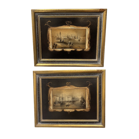 Two framed black and gold artworks on a white background
