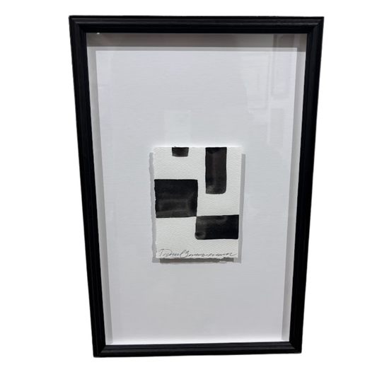 Framed black and white abstract artwork on a white background