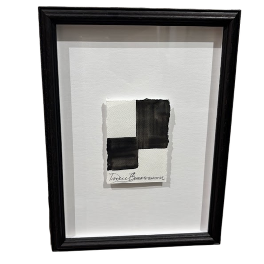 Framed abstract artwork with black and white brush strokes on a white background