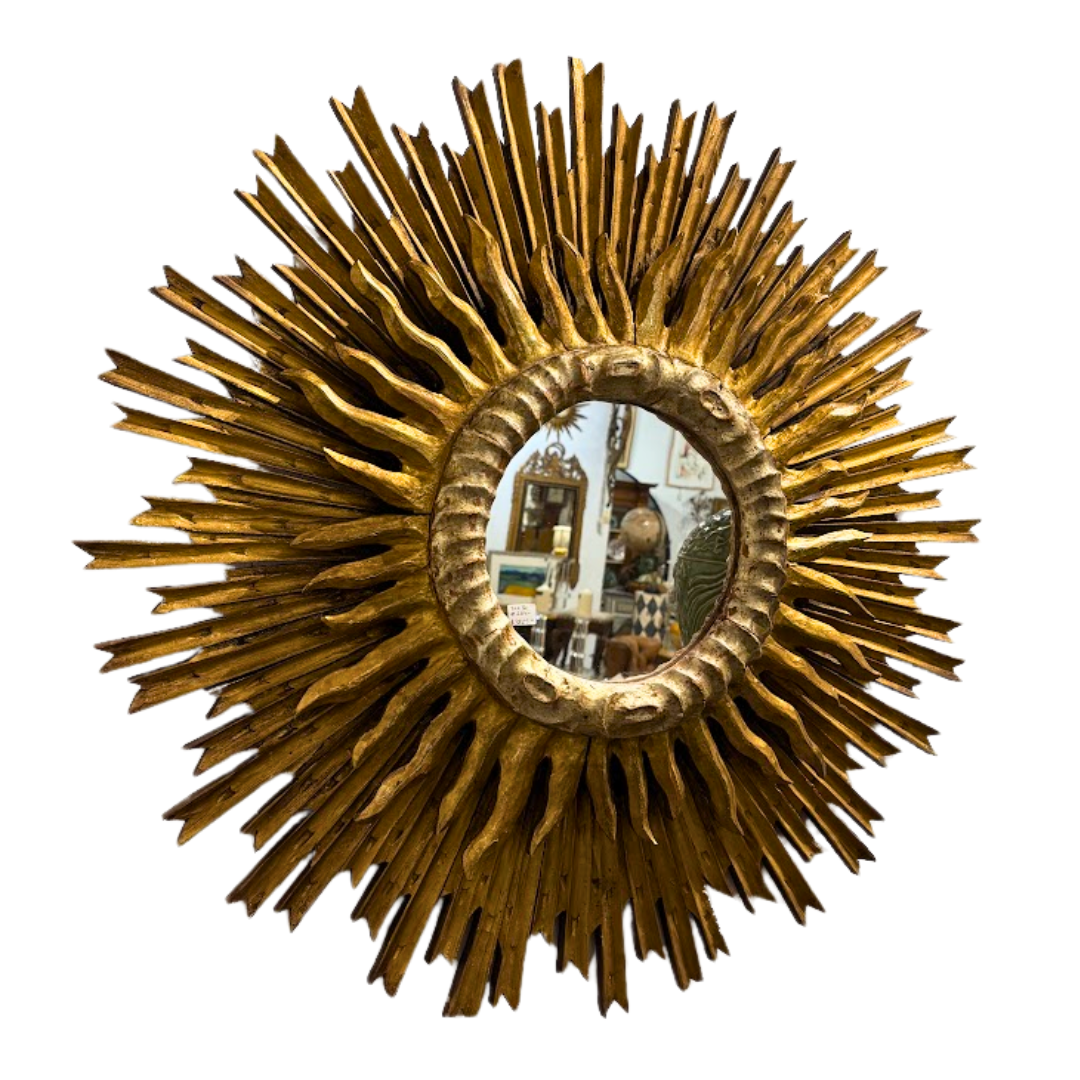 Gold sunburst mirror on a white background