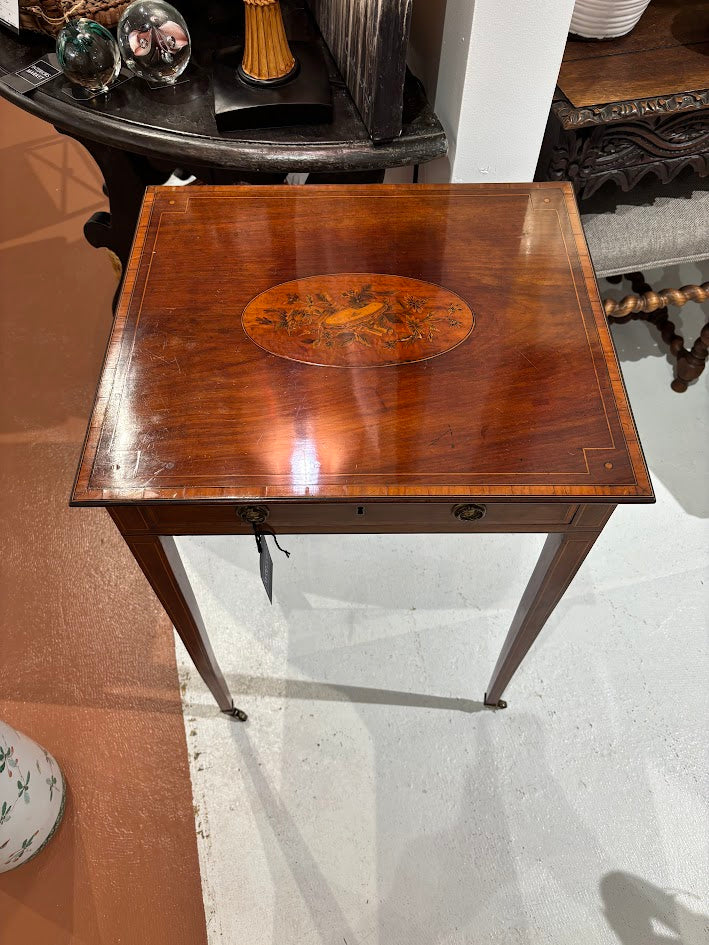 Wooden side table with decorative inlay in a room setting