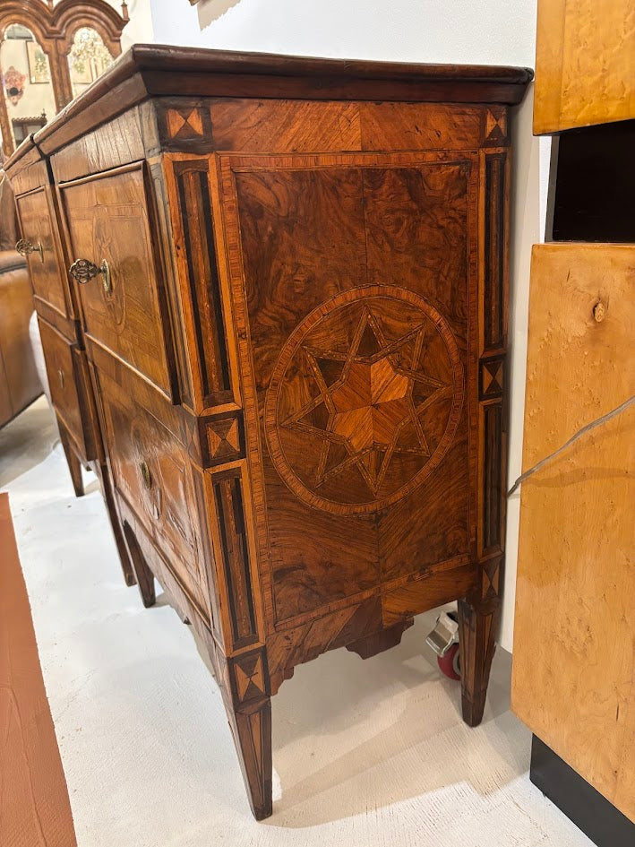 Wooden dresser with intricate star design in a store setting