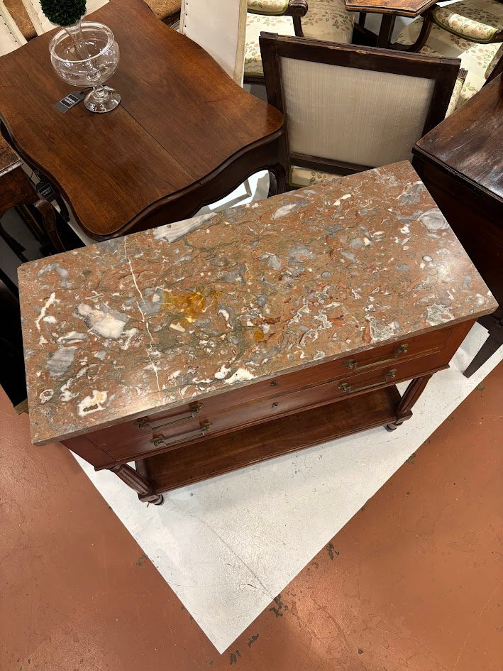 Vintage wooden table with marble-like top in a showroom setting
