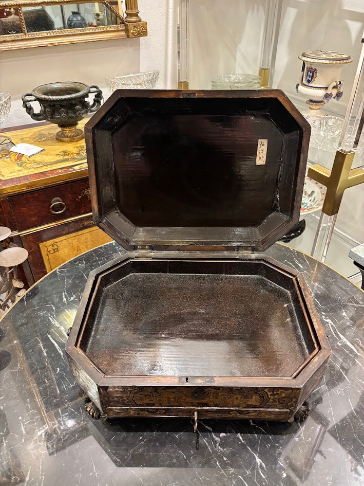 Wooden octagonal box on a marble surface with a reflective background