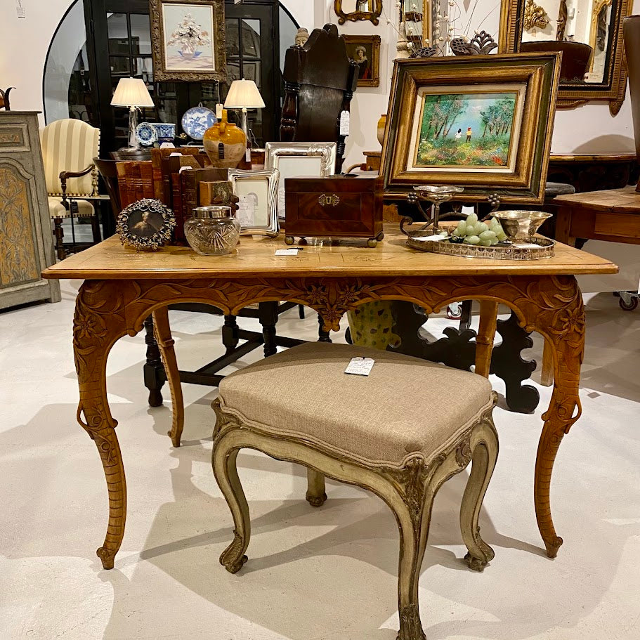 Antique console tables and vintage center tables on display at Interiors Market Atlanta