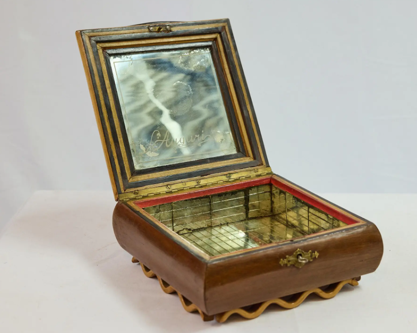 Wooden jewelry box with mirror lid on a white background
