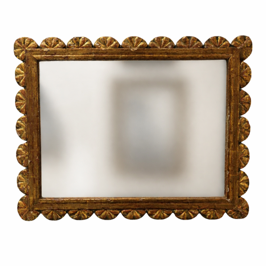 Decorative mirror with a gold frame on a white background