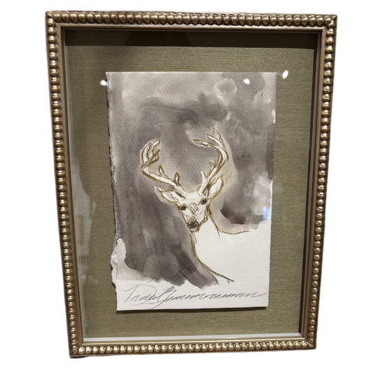 Framed artwork of a deer head with gold antlers on a textured background
