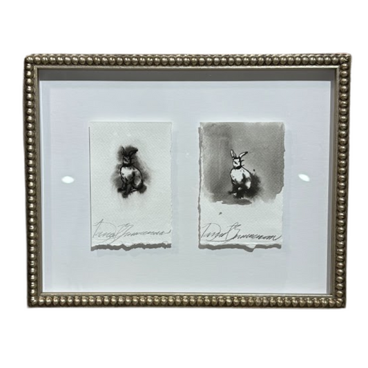 Framed artwork with two black and white sketches of animals on a white background.