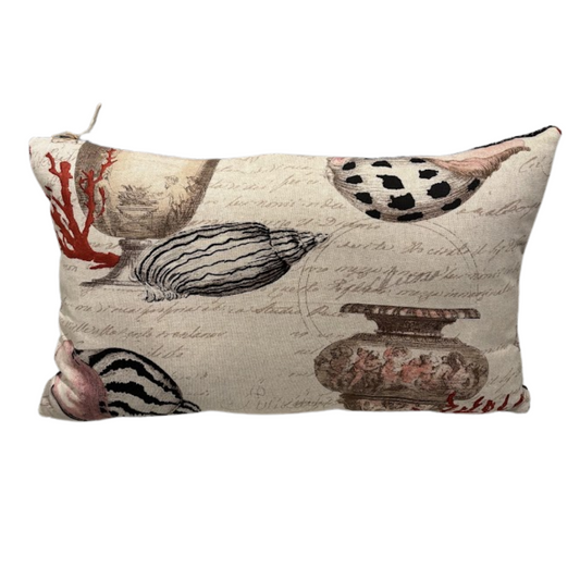 Decorative pillow with shell and coral design on a beige background