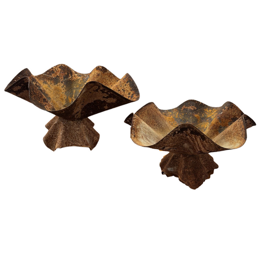 Two decorative metal bowls with a rustic, wavy design on a white background.