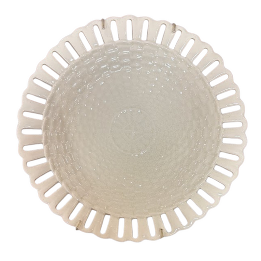 Round ceramic plate with decorative rim on a white background