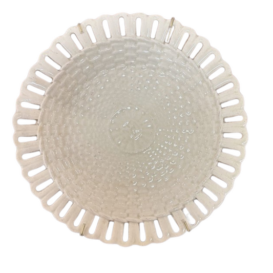 Round woven basket with a textured surface on a white background