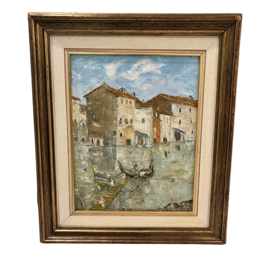 Framed painting of a canal scene with buildings and boats.