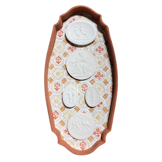 Decorative wall art with four circular white figures on a patterned background