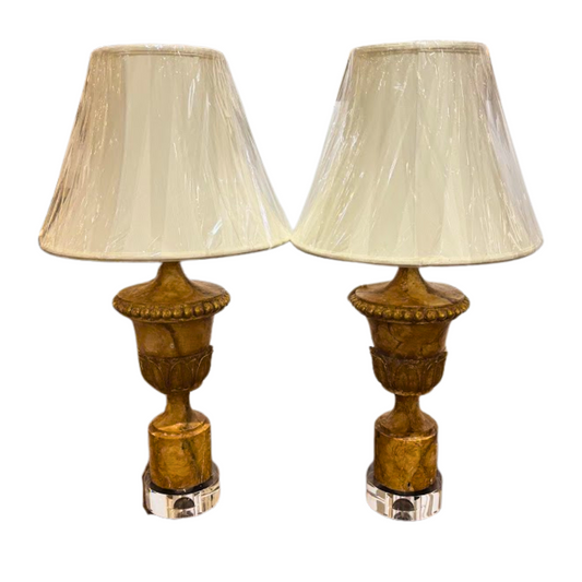 Pair of table lamps with decorative bases and beige lampshades on a white background