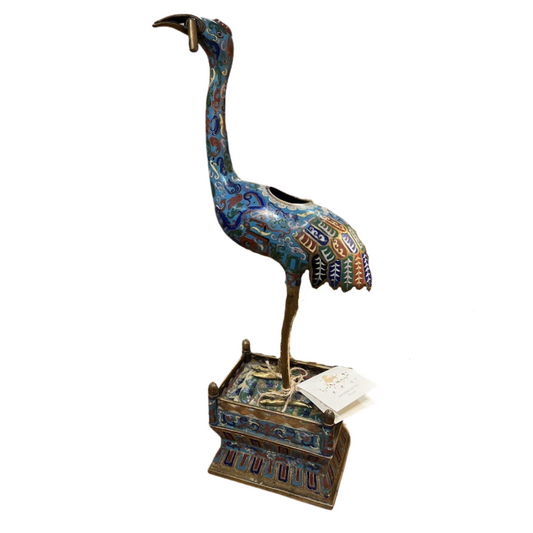 Decorative bird sculpture with intricate patterns on a white background
