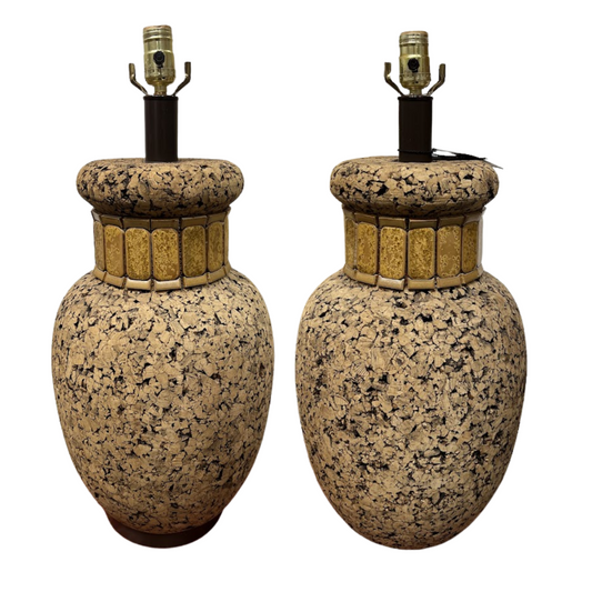 Pair of speckled cork lamps on a white background