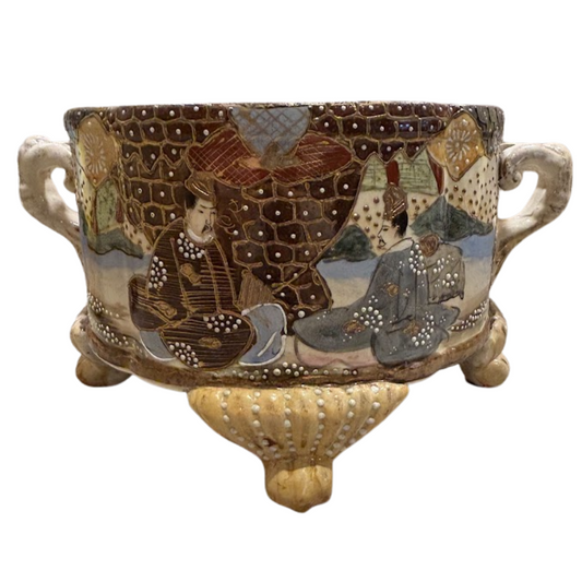 Decorative ceramic pot with artistic designs on a white background