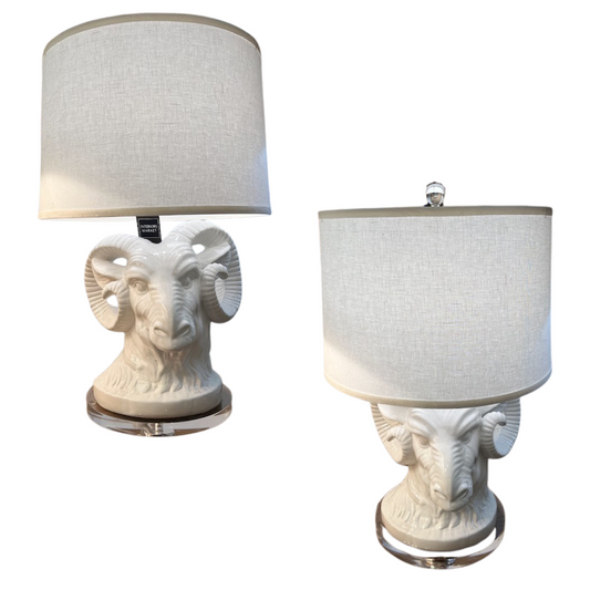 Two table lamps with ram head designs on a white background
