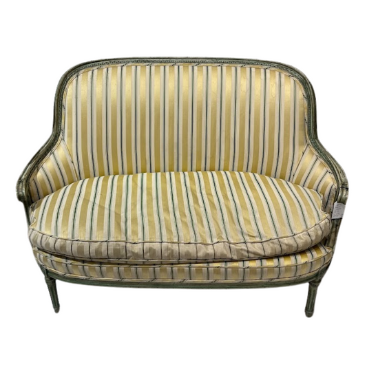 Striped sofa with a green and yellow pattern on a white background