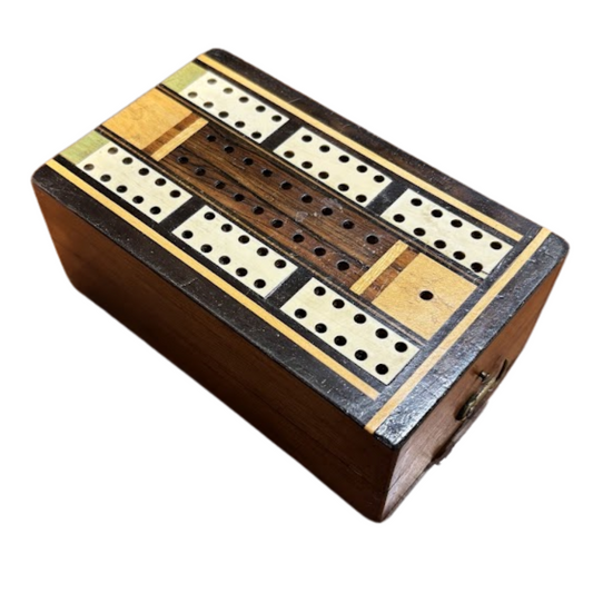 Wooden cribbage board with multiple peg slots on a white background