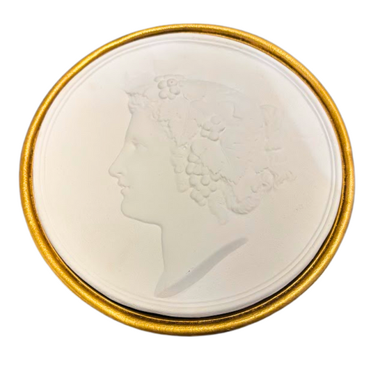Medallion with profile portrait in a gold frame on a white background