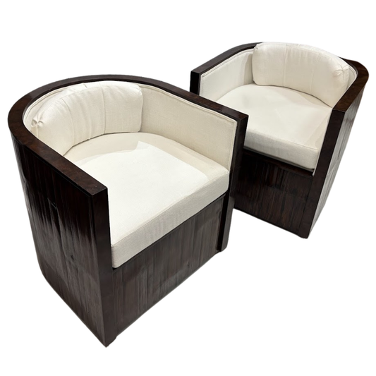 Two modern chairs with white cushions and dark wood frames on a white background
