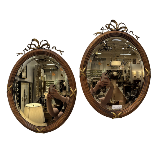 Two round mirrors with decorative wooden frames on a white background