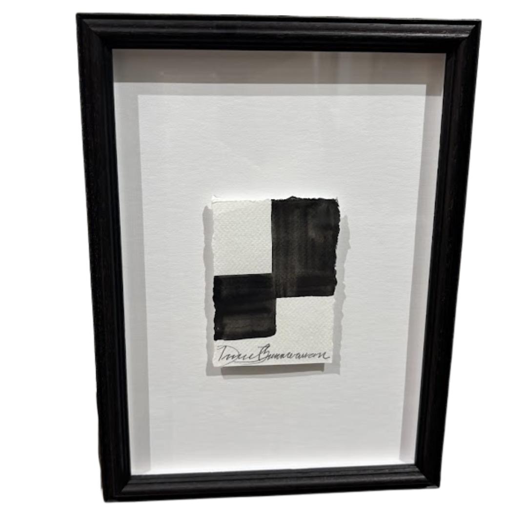 Framed abstract artwork with black and white brush strokes on a white background