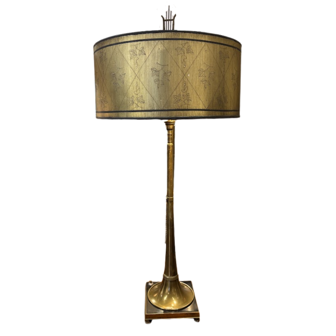 Decorative lamp with a gold and black shade on a white background