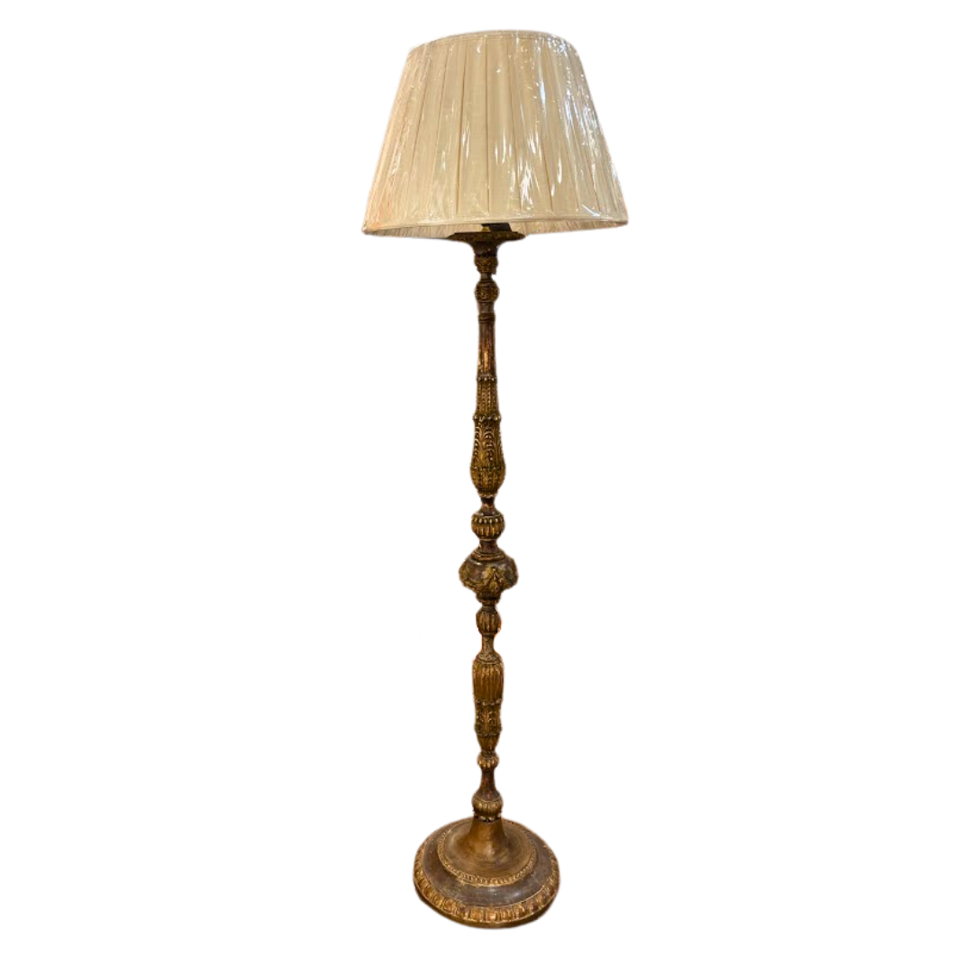Decorative floor lamp with a pleated beige shade on a white background
