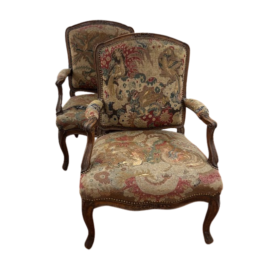 Pair of ornate chairs with floral patterns on a white background