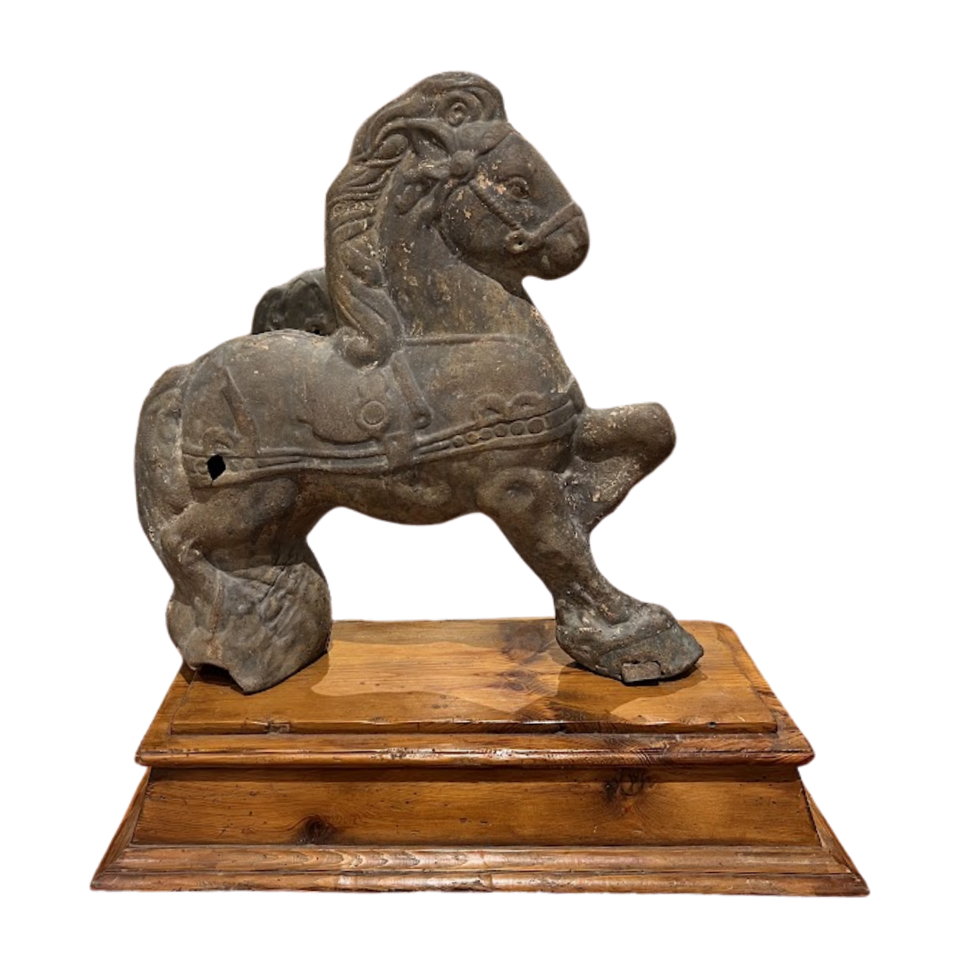 metal horse sculpture on a wooden base against a white background