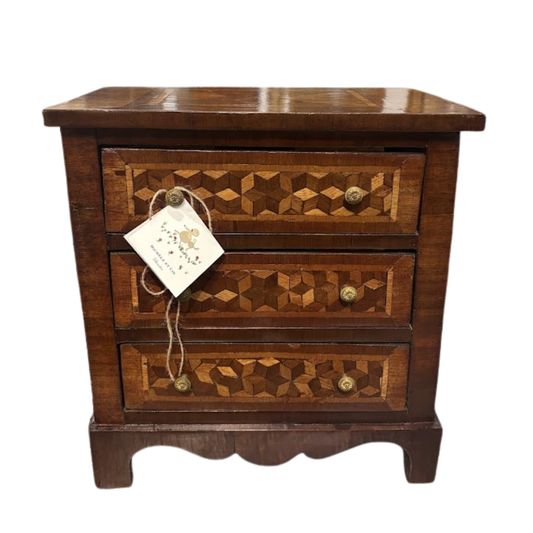 Wooden nightstand with geometric inlay design and a tag on a white background