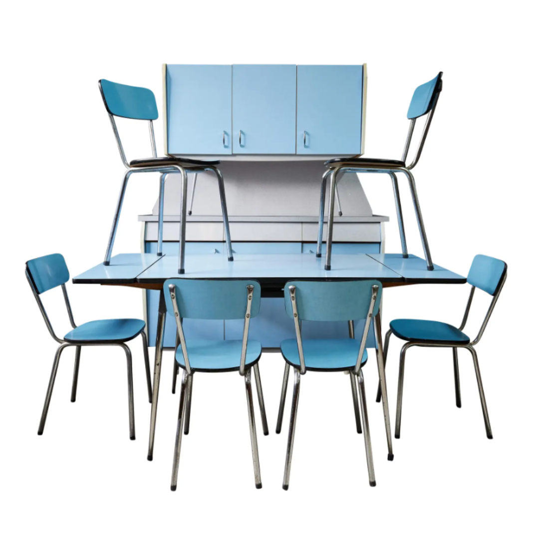 Blue dining table set with chairs against a white background