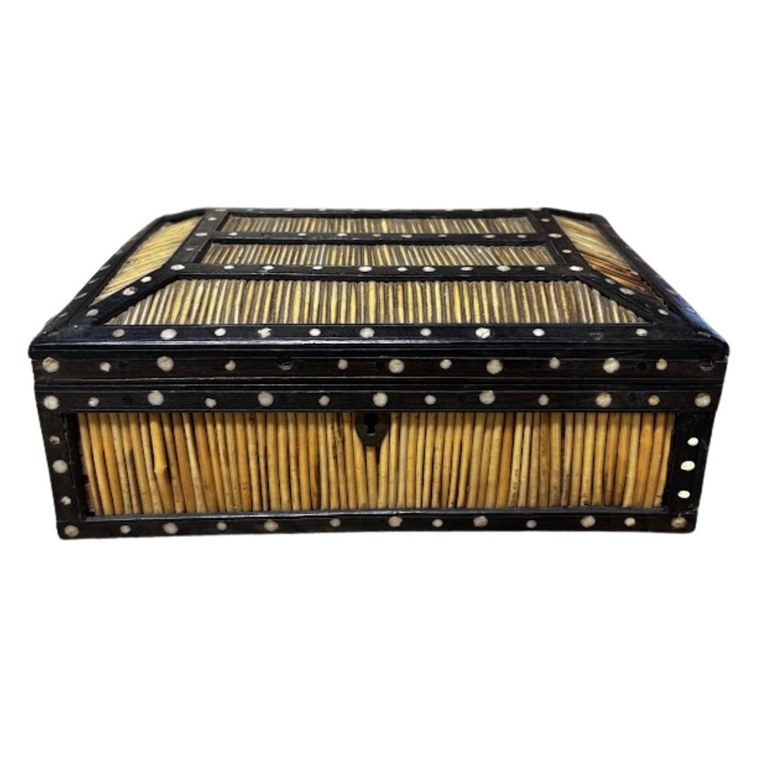 Decorative wooden box with black frame and gold interior on a white background