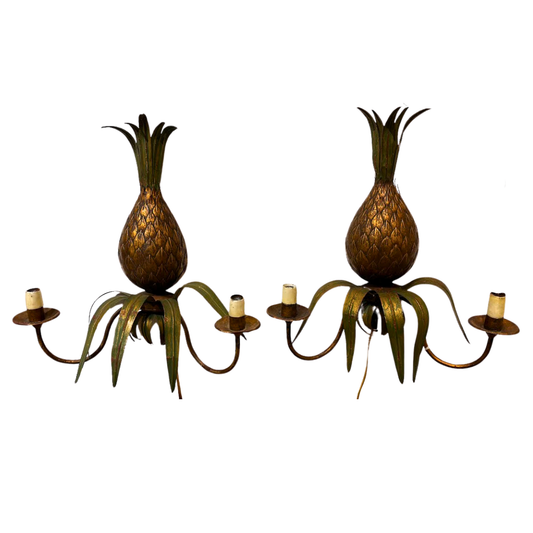 Pineapple-shaped sconces on a white background