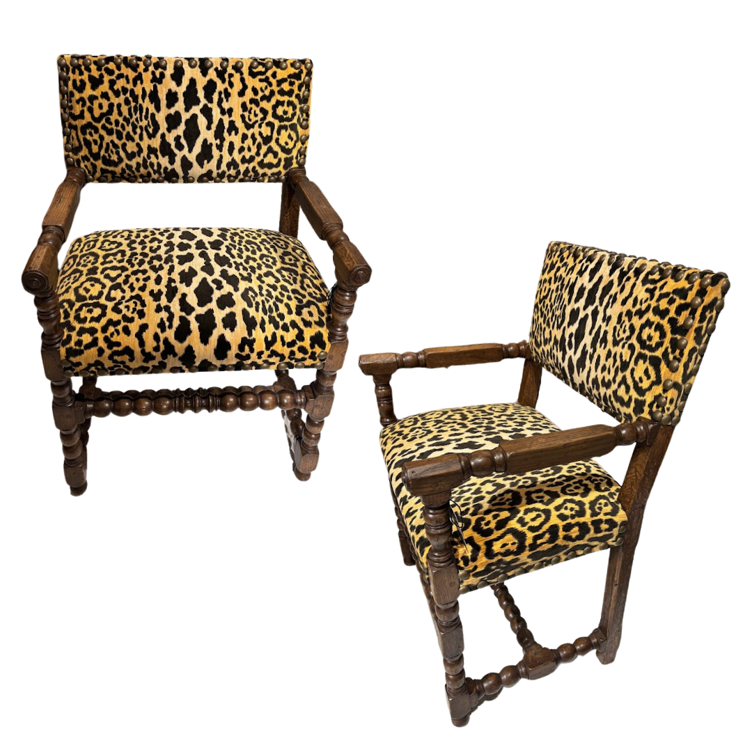 Two wooden chairs with leopard print cushions on a white background