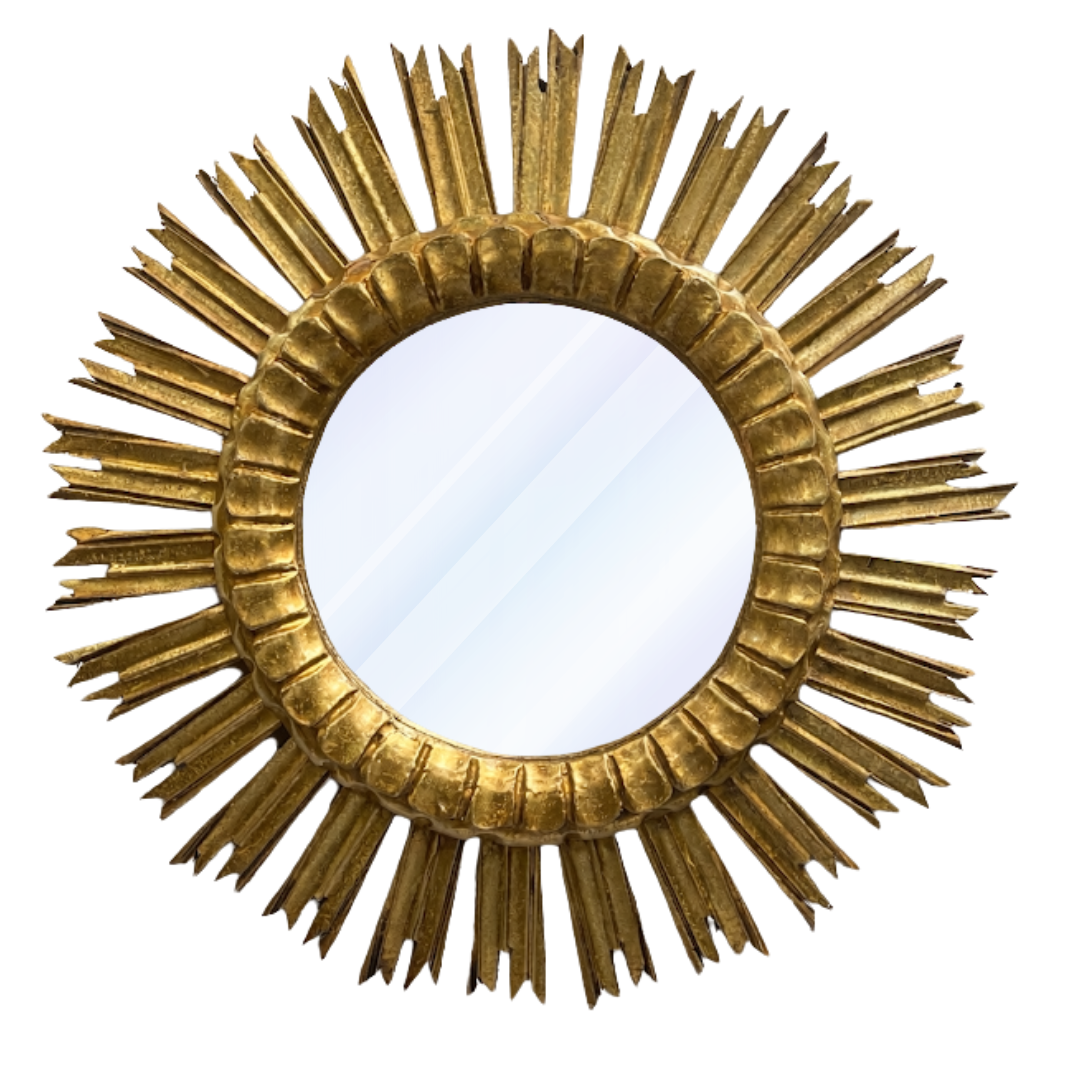 Gold sunburst mirror on a white background