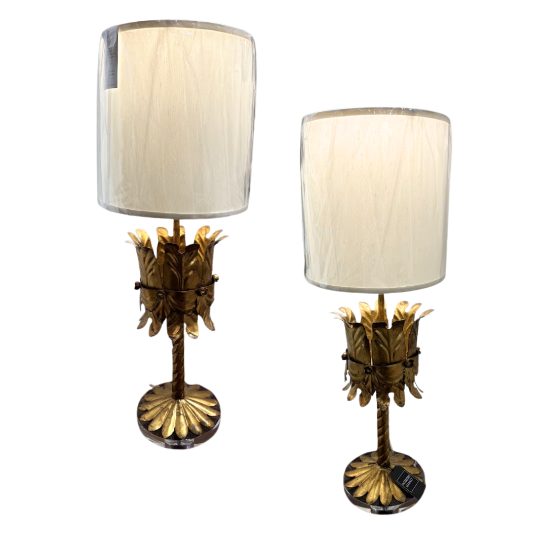 Two ornate table lamps with gold bases and white lampshades on a white background
