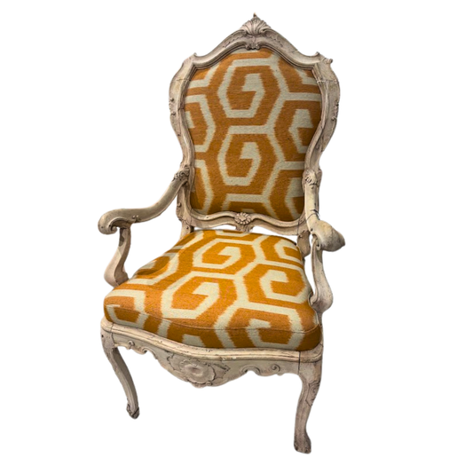 Decorative chair with gold and white geometric pattern on a white background