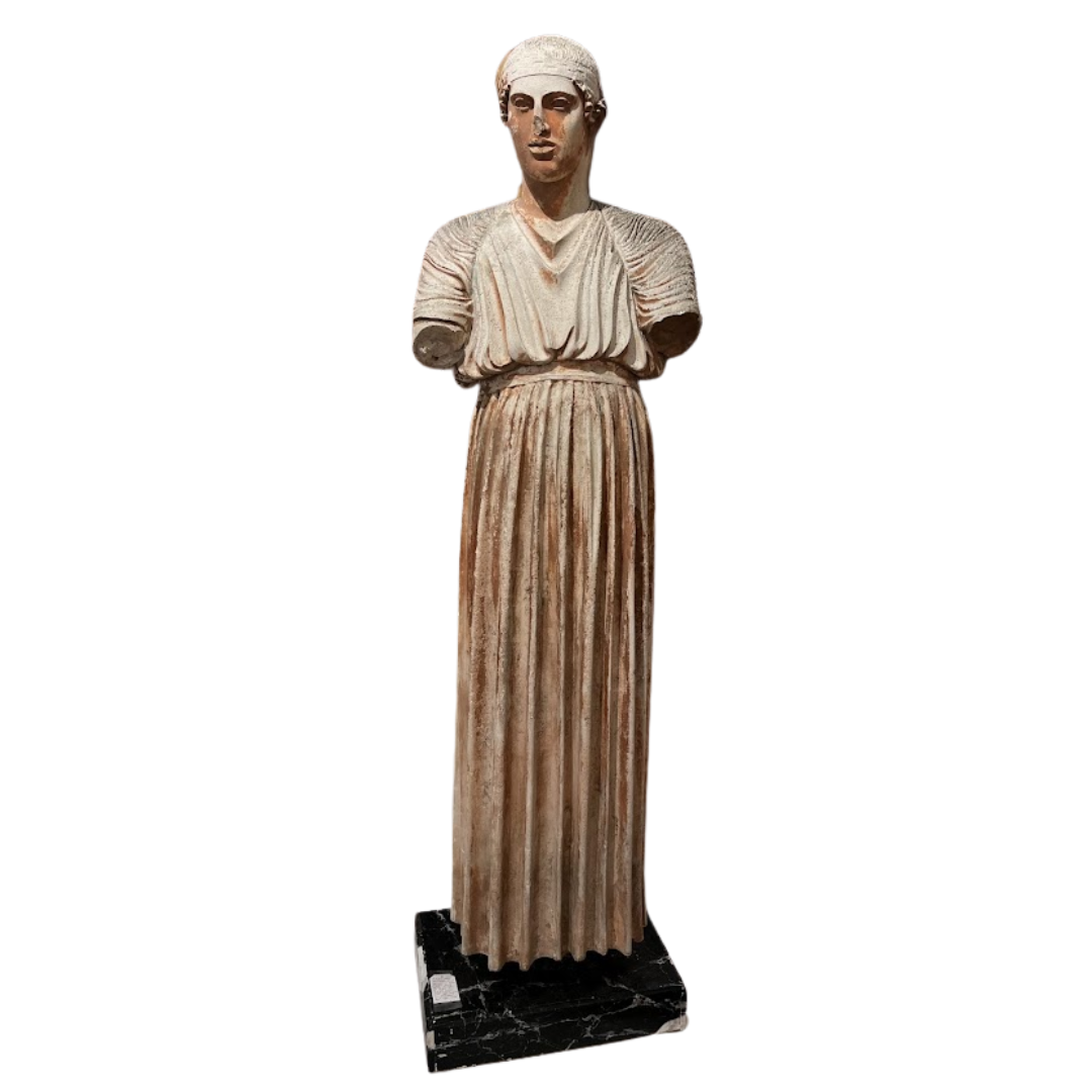 Statue of a draped figure on a white background
