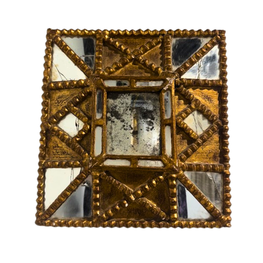 Decorative square mirror with gold frame and reflective surface on a white background