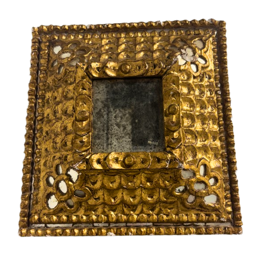 Decorative gold frame with intricate patterns on a white background