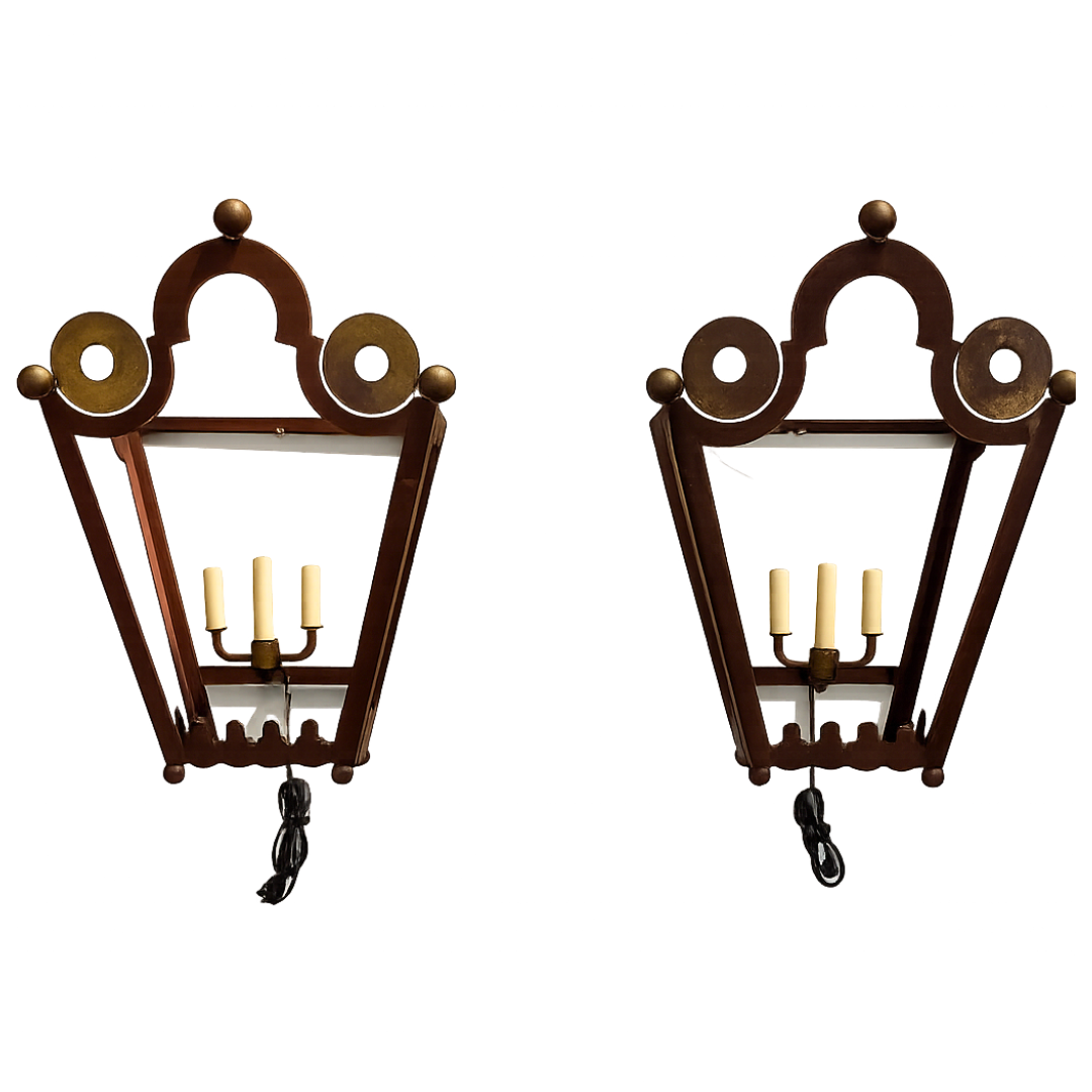 Pair of decorative wall sconces with tole frames and candle-like lights on a white background.